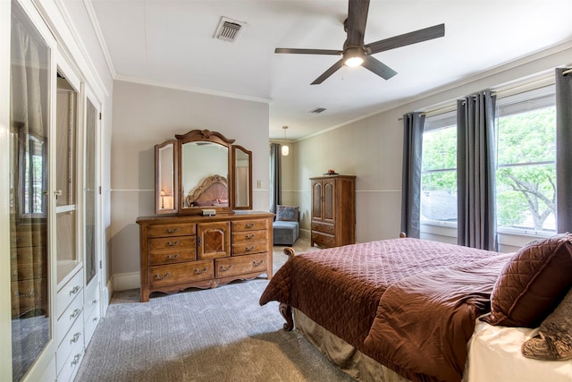 bedroom featuring ceiling fan, visible vents, ornamental molding, and carpet