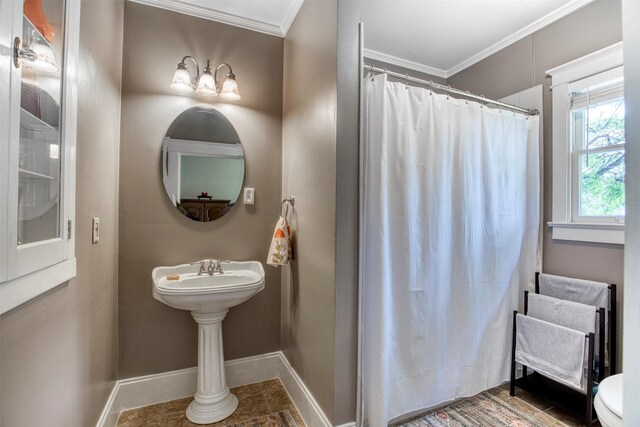 bathroom featuring toilet, baseboards, ornamental molding, and a shower with shower curtain