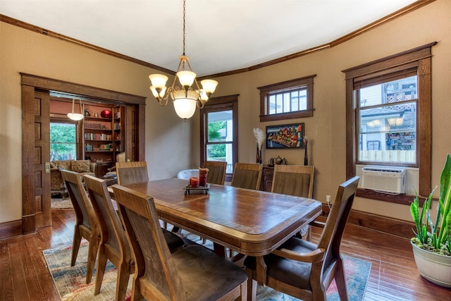 dining area with cooling unit, a notable chandelier, plenty of natural light, and hardwood / wood-style floors