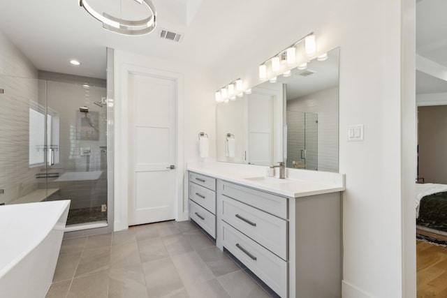 full bathroom with a freestanding tub, visible vents, a shower stall, and vanity