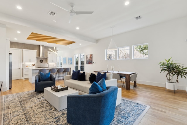 living area featuring visible vents, recessed lighting, ceiling fan, and light wood-type flooring