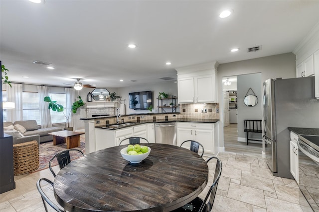 dining space featuring a ceiling fan, visible vents, recessed lighting, and a fireplace