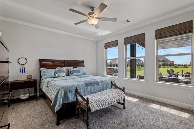 bedroom with visible vents, ornamental molding, baseboards, ceiling fan, and carpet