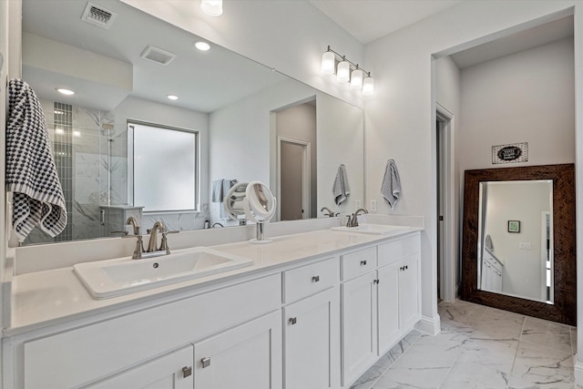 bathroom with double vanity, visible vents, a shower stall, a sink, and marble finish floor