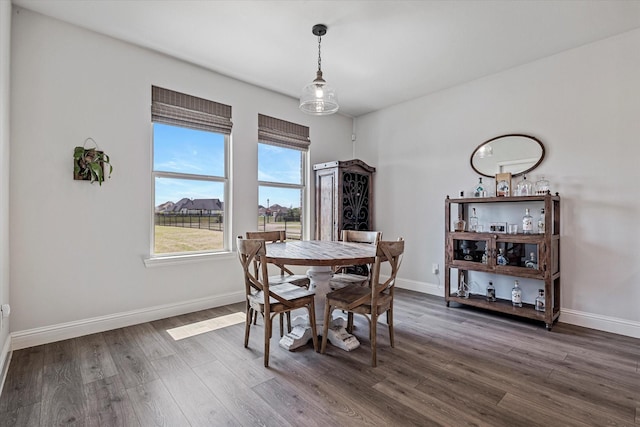 dining room with baseboards and dark wood-style floors