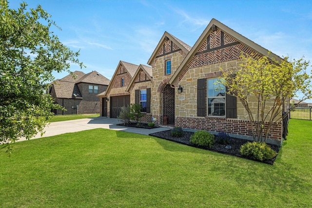 view of front of property featuring driveway, a front yard, a garage, fence, and stone siding