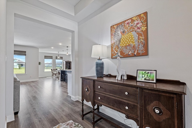 hall featuring baseboards, recessed lighting, and wood finished floors