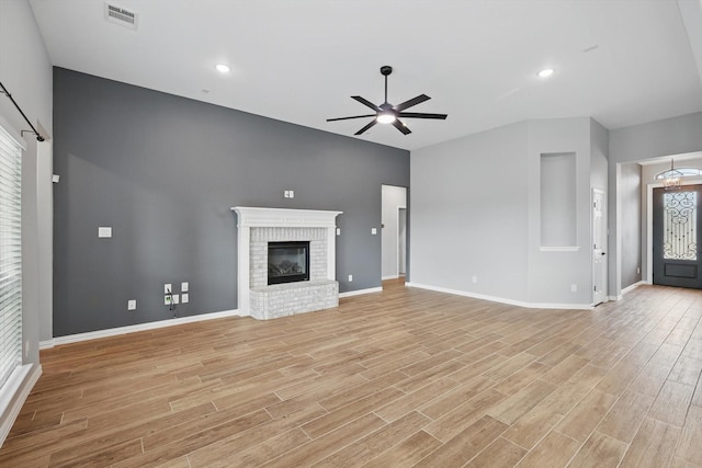 unfurnished living room featuring light wood-style floors, visible vents, baseboards, and a ceiling fan