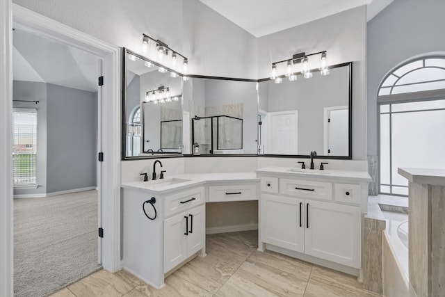 full bath featuring a sink, double vanity, and a garden tub