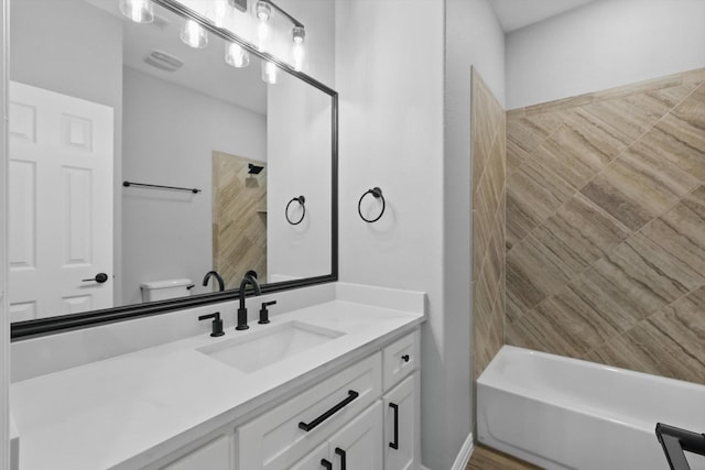 full bath featuring toilet, bathing tub / shower combination, and vanity