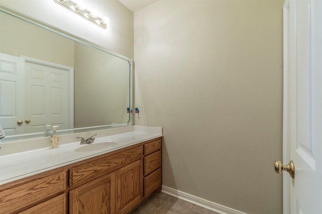 bathroom featuring baseboards, tile patterned flooring, and vanity