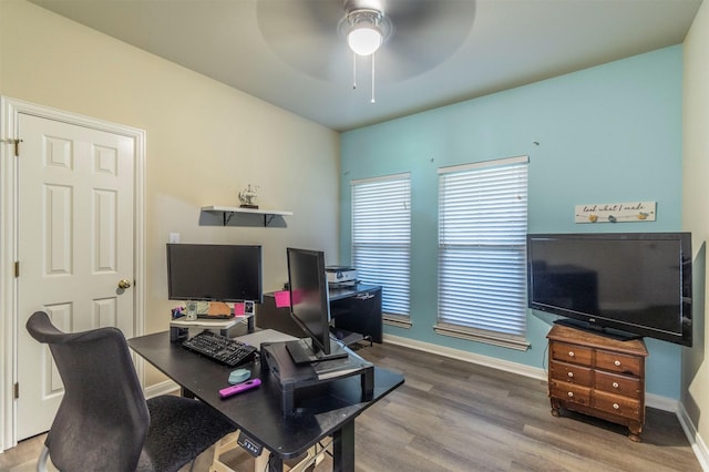 office area with plenty of natural light, baseboards, ceiling fan, and wood finished floors