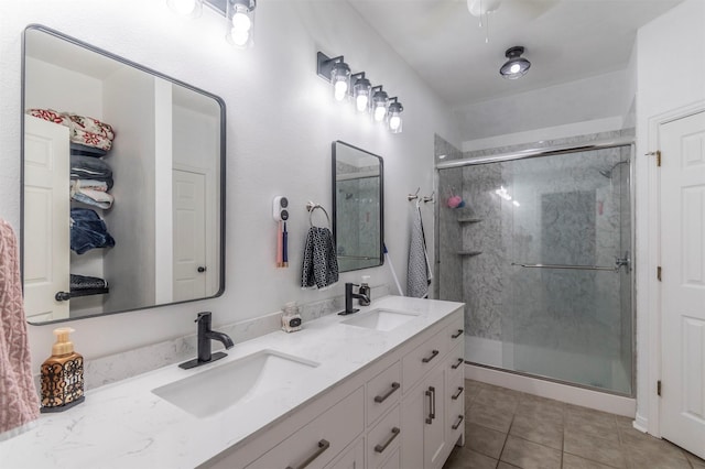full bath featuring a sink, tile patterned flooring, and a stall shower