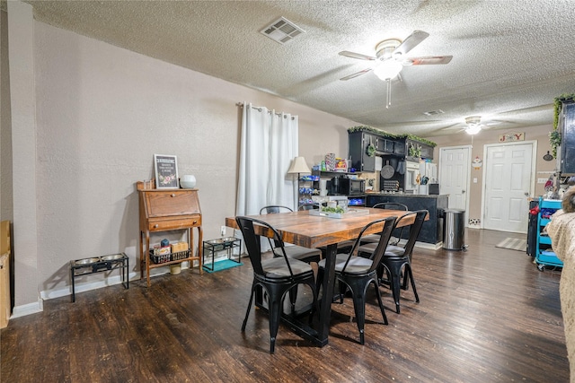 dining area featuring a textured ceiling, ceiling fan, visible vents, and dark wood-type flooring