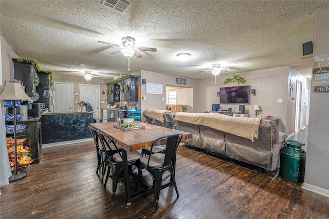 dining space with baseboards, ceiling fan, visible vents, and wood finished floors