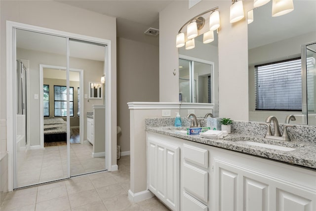 full bath featuring double vanity, tile patterned floors, visible vents, and a sink