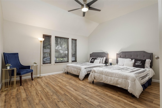 bedroom with baseboards, a ceiling fan, wood finished floors, and vaulted ceiling