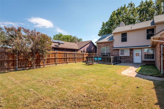 view of yard with a fenced backyard and a deck