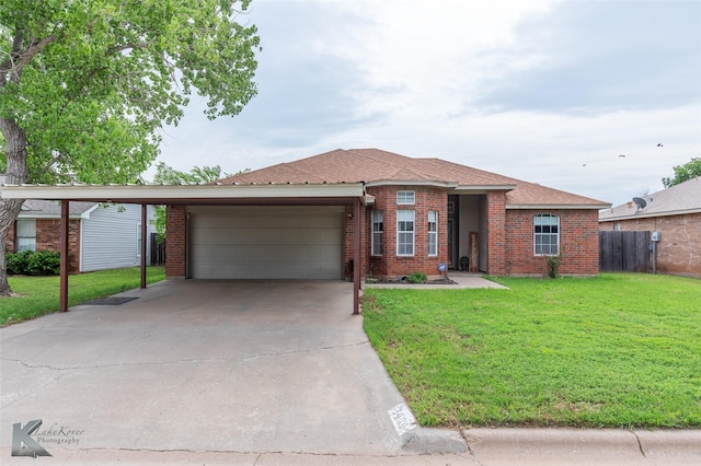 ranch-style home with fence, an attached garage, a front yard, and brick siding