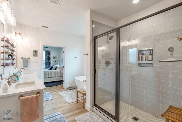 bathroom featuring ensuite bath, visible vents, a sink, and a stall shower