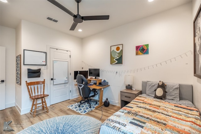 bedroom with baseboards, recessed lighting, wood finished floors, and visible vents