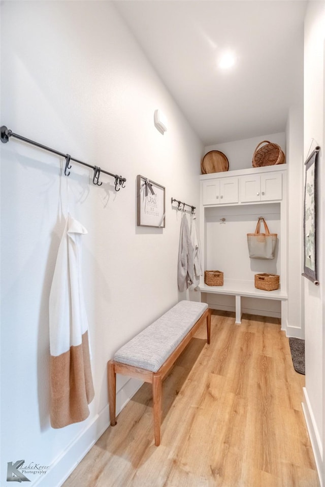 mudroom with light wood-style floors and baseboards