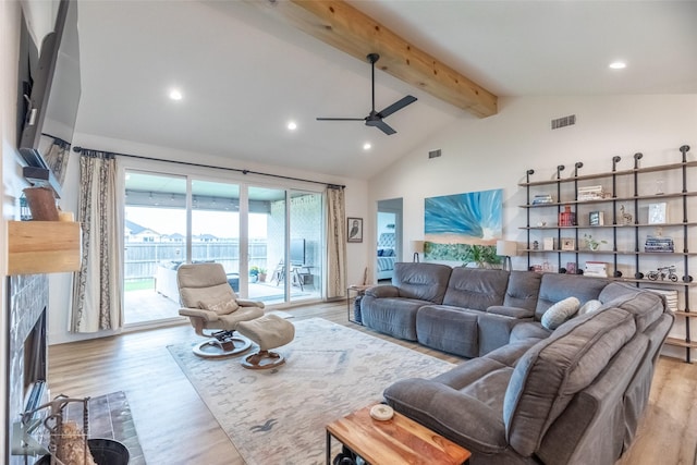 living area featuring a ceiling fan, beamed ceiling, visible vents, and light wood finished floors