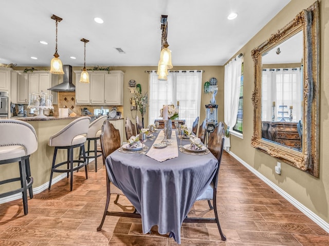dining space featuring baseboards, recessed lighting, and wood finished floors