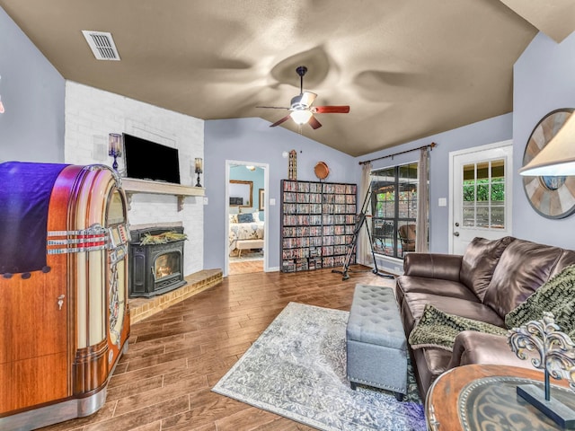 living room with wood finished floors, ceiling fan, lofted ceiling, and visible vents