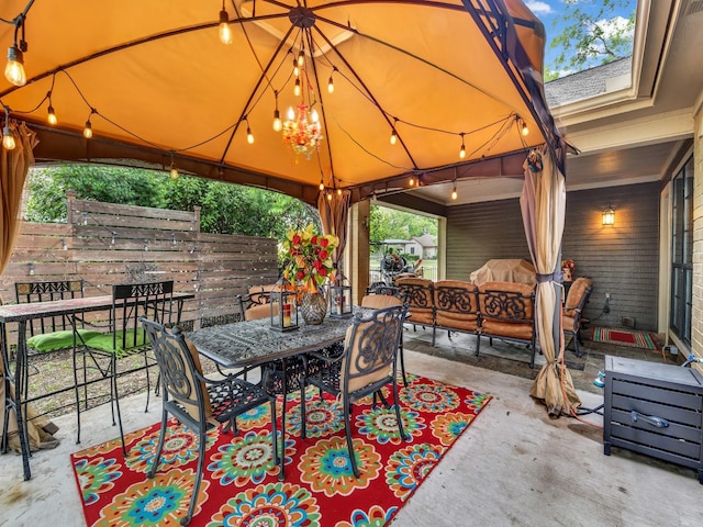 view of patio featuring fence, outdoor dining space, a gazebo, and outdoor lounge area