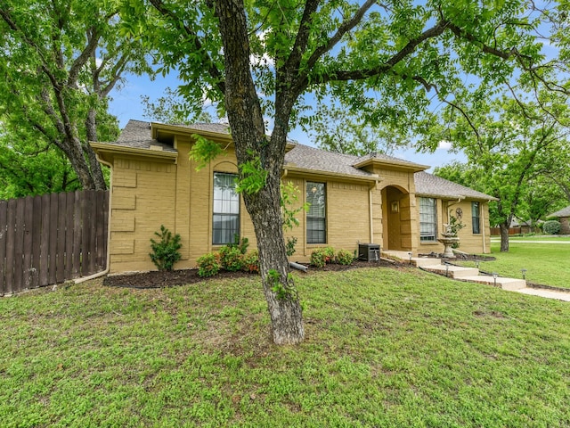 ranch-style house featuring fence, central AC, a front lawn, and brick siding