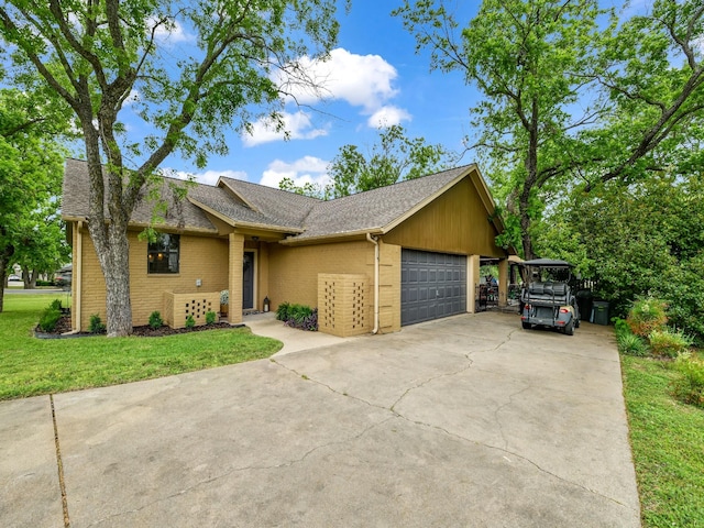 ranch-style home featuring a front yard, a garage, brick siding, concrete driveway, and a shingled roof