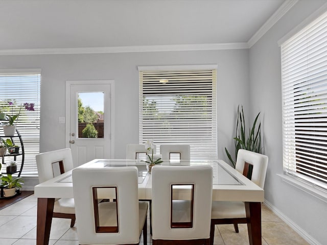 dining area with crown molding, light tile patterned floors, and baseboards