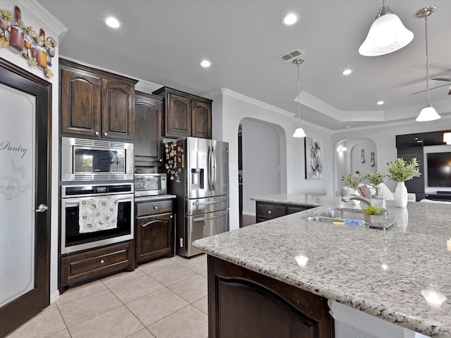 kitchen with a sink, arched walkways, stainless steel appliances, light tile patterned floors, and visible vents