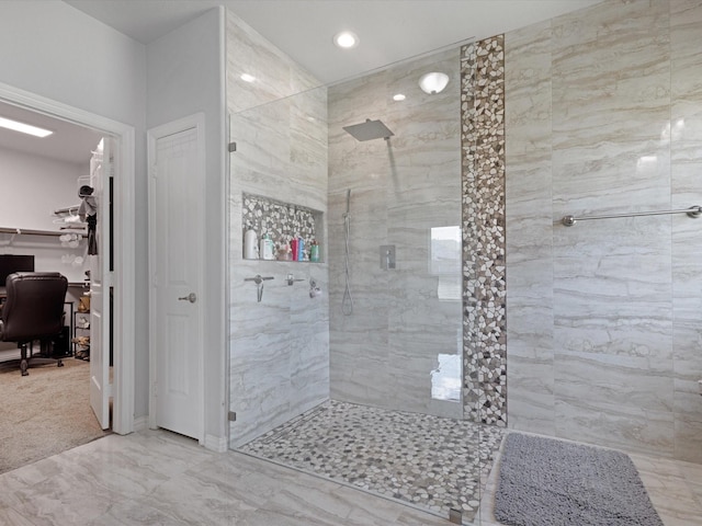 bathroom featuring recessed lighting, tiled shower, and marble finish floor