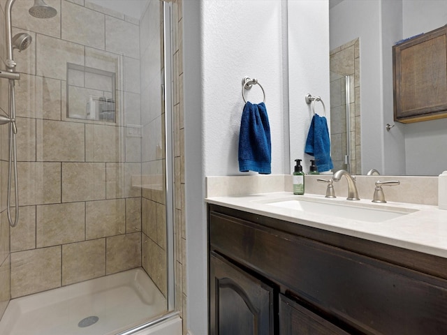 bathroom featuring vanity and a shower stall