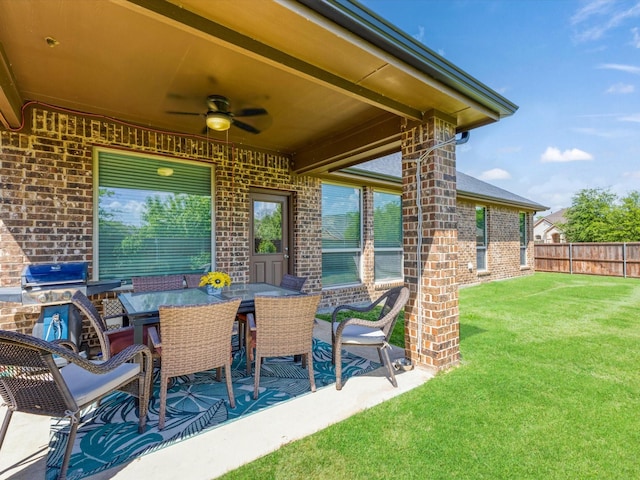 view of patio / terrace with a ceiling fan and fence