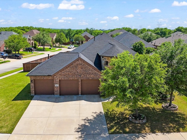 view of front of house featuring a garage, a front lawn, brick siding, a shingled roof, and concrete driveway