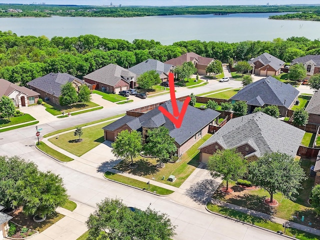 drone / aerial view featuring a water view and a residential view