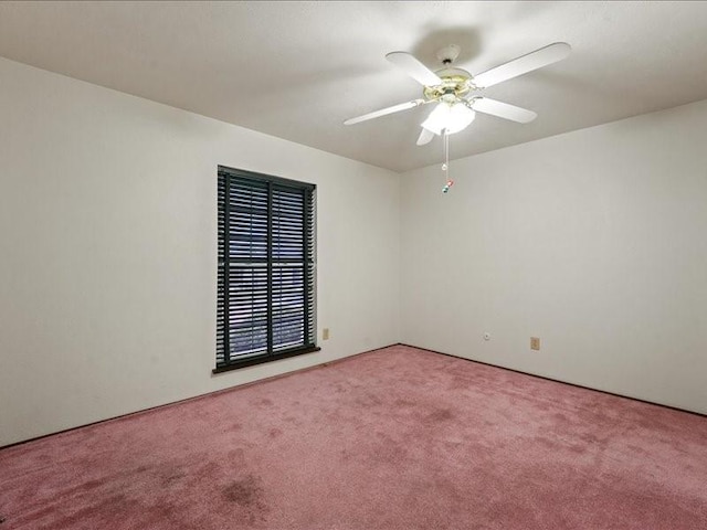 carpeted empty room with a ceiling fan