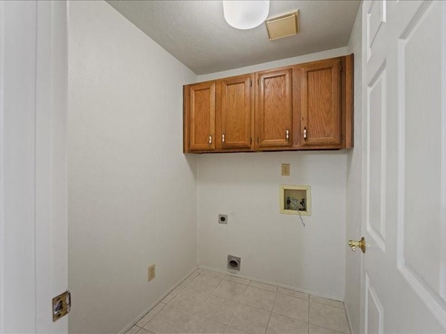 washroom featuring cabinet space, electric dryer hookup, and washer hookup