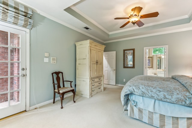 bedroom with ornamental molding, a tray ceiling, and visible vents