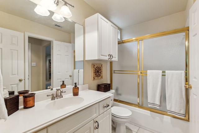 full bath featuring tile patterned flooring, vanity, toilet, combined bath / shower with glass door, and visible vents