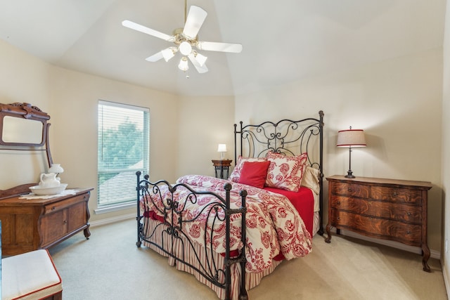 bedroom with baseboards, ceiling fan, vaulted ceiling, and light colored carpet
