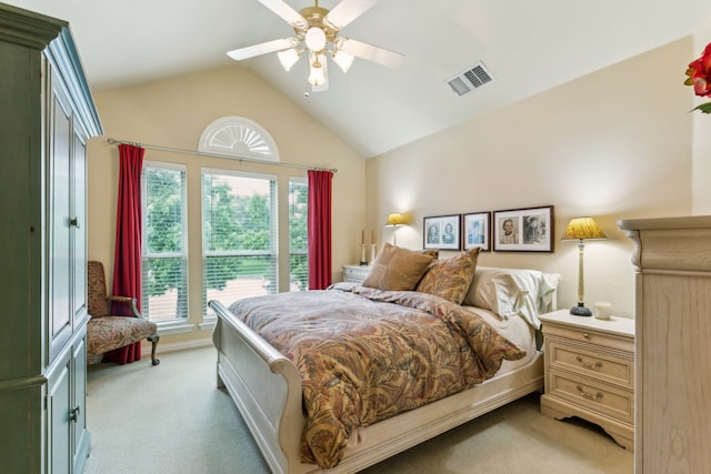 bedroom with vaulted ceiling, ceiling fan, light colored carpet, and visible vents