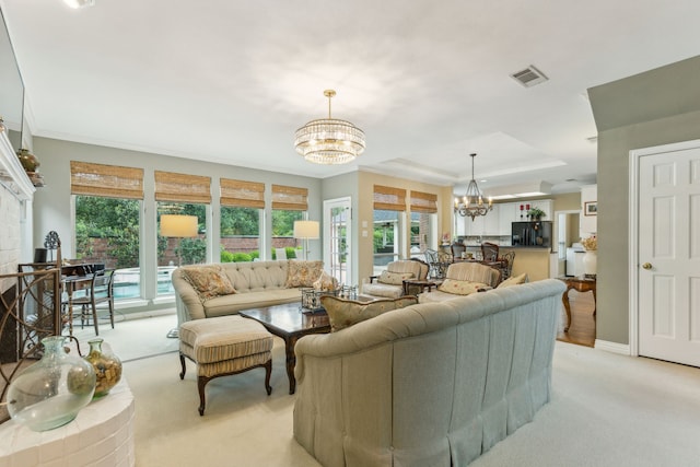living area featuring an inviting chandelier, a raised ceiling, visible vents, and light colored carpet