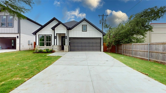 modern inspired farmhouse featuring board and batten siding, fence, driveway, and a front yard