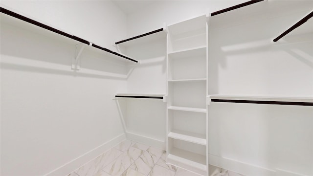 spacious closet with marble finish floor