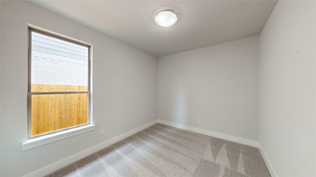 carpeted spare room with baseboards