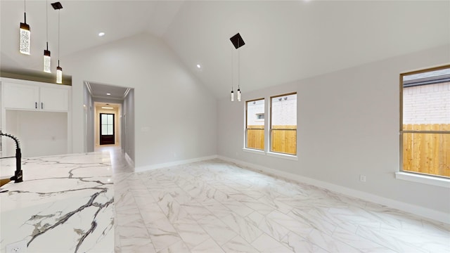 unfurnished living room featuring recessed lighting, high vaulted ceiling, baseboards, and marble finish floor